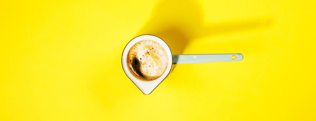 Coffee on yellow background, flat lay, top view