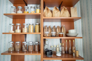 Various foods, cereals, in bags and cans on the shelves. Food for vegetarians.