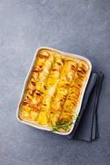 Potato gratin, backed potato slices with creamy sauce. Top view.