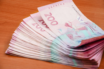 200 hryvnia on a wooden table. Close-up.