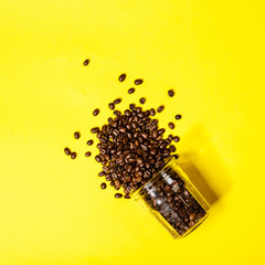 Coffee beans on yellow background, flat lay, top view