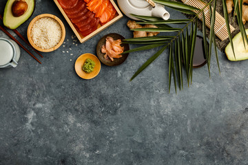 Overhead shot of ingredients for sushi on dark blue background