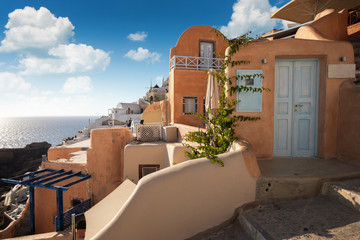 Beautiful streets of Oia, Santorini with the blue sea in the background