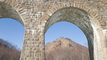 Arch Circum-Baikal railway in the spring day. A journey to lake Baikal in Russia