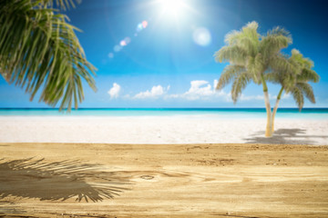 Fototapeta premium Desk of free space and summer landscape with palms and ocean 