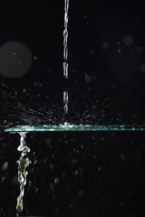 Agua creando formas al caer sobre un cristal