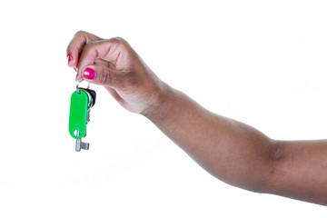 African woman hand holds keys on white background