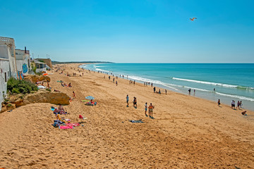 Armacao de Pera, Portugal - April 21, 2019: People enjoying at the beach in Armacao de Pera in the Algarve Portugal