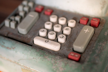 Old calculator antique cash registerAntique machinery,vintage style,Plus key,soft focus.