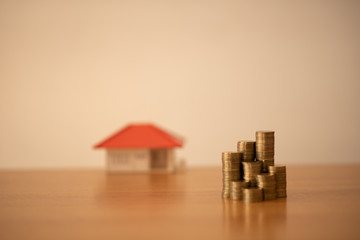 Small house add coin column The concept of saving money, investment properties