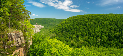 Tourist visitors couple taking pictures at Whitaker Point rock cliff hiking trail, landscape view,...