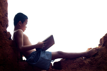 Asian boys are reading books in the clay house.