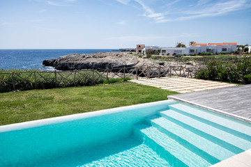 Swimming pool stairs next to the sea