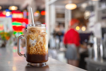Sweet iced coffee milk latte drink served at fun colorful american diner restaurant