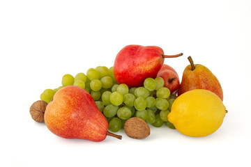Bright ripe red pears walnuts with lemon branch of green grapes on white background