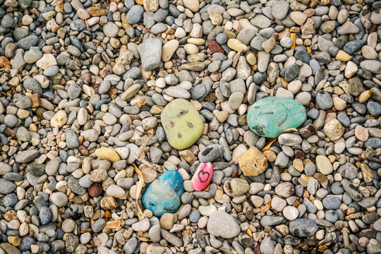 Stones painted by children on a beach