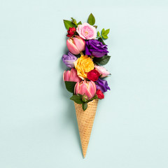 Ice cream cone with flowers and leaves. Summer minimal concept.