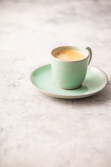 A cup of coffee on light grey background