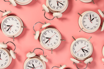 White alarm clock on pink background - pattern