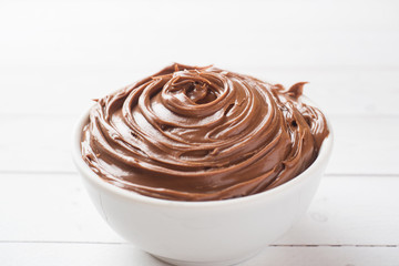 Nougat nut chocolate in a plate on a white background. Selective focus.