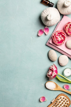 Flat lay of spa treatment set with pink flowers