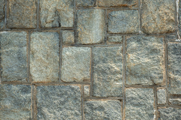Close up of rough stone wall. Texture wallpaper and background concept.