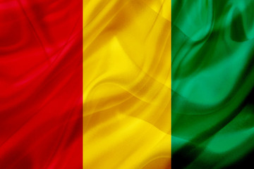 Guinea country flag on silk or silky waving texture