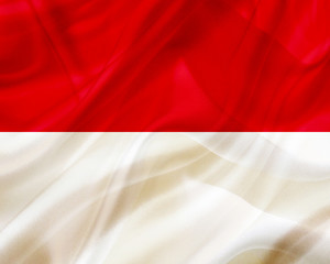 Monaco country flag on silk or silky waving texture