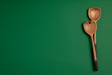 Wooden serving spoons on colorful background