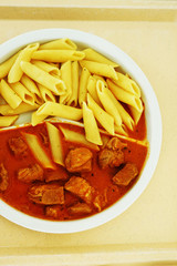 Goulash with sauce and noodles served for dinner on the tray