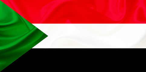 Sudan country flag on silk or silky waving texture