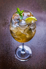Cool summer cocktail with ice cube, lime, mint leaves and fresh lime juice.