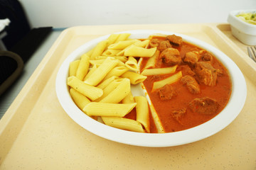 Goulash with sauce and noodles served for dinner on the tray