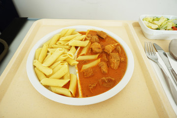 Goulash with sauce and noodles served for dinner on the tray
