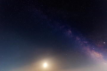 The Milky Way and the moon in the night sky