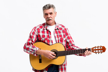 Obraz premium Handsome mature man in casual clothes is looking at camera and smiling while playing guitar isoalted on white background!