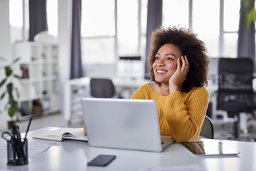 Cute mixed race businesswoman dressed  casual thinking how to solve a problem while sitting in...