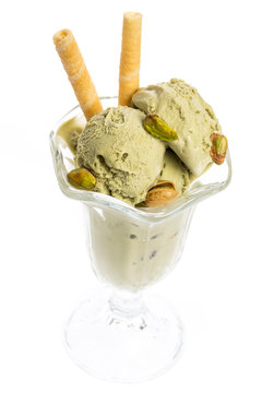 pistachio ice cream sundae with waffles and pistachio kernel isolated on white background - top view