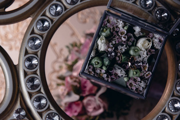 Wedding rings lie on a flower close up