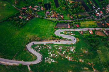 Curvy road from a drone view and agriculture fields