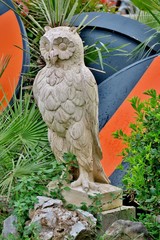 statue of owl carved from white stone close up