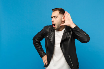 Handsome stylish young bearded man in black leather jacket white t-shirt try to hear you isolated...