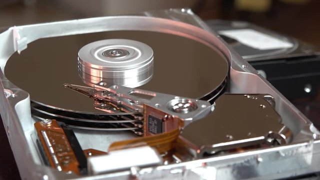 Close-up of an operating computer harddisk reading and writing data