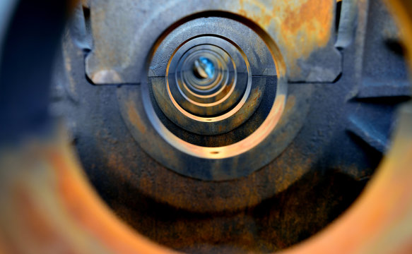 A tunnel or series of symmetrical circular holes with progressively smaller patterns to the distant horizon.