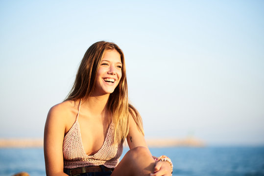 Positive young girl in knitted top in sunlight