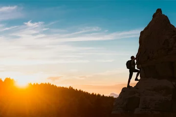 Foto op Plexiglas silhouette of successful climbing woman in mountains Concept of concept of motion motivation inspiration at beautiful sunset © Kotangens