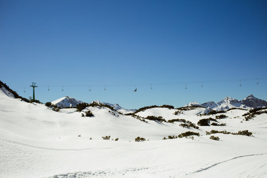 View from the mountains with a ski lift in the background
