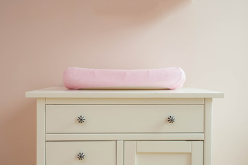 Changing mat in baby room modern design, pink colors