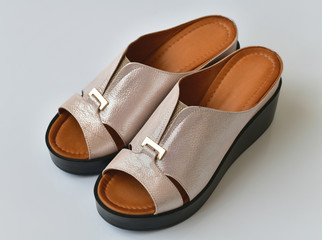 Beautiful female clogs on a white background