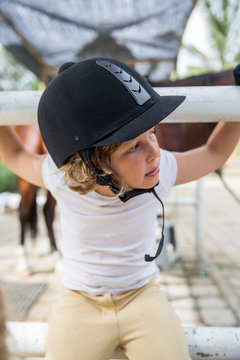Young girl at the horse stable